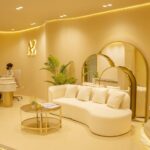 Reception lounge with logo, sofa, and staff at desk, AE Browart Award-Winning Eyebrow Embroidery Specialist, Petaling