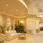 Elegant modern lounge interior with curved sofa and plants, AE Browart Award-Winning Eyebrow Embroidery Specialist, Petaling
