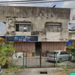 Weathered building with service company signboard behind gate, AirconPro (HQ), Setapak