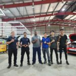 Workshop team posing inside garage with cars, Bavarian Motoren Malaysia - BMW Specialist, Cheras