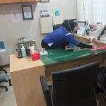 Cleaner wiping desk in an office, Cleaning Resources Malaysia, Puchong