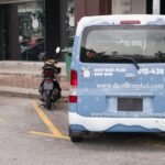 Branded delivery van parked outside shopfront, Dustbox Plus Sdn. Bhd, Petaling Jaya
