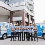 Staff posed in front of branded service vans, Dustbox Plus Sdn. Bhd, Petaling Jaya