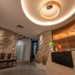 Reception lobby with stone wall and logo signage, Hair Library, Petaling Jaya