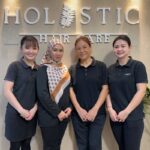 Staff posed in front of salon signage, Holistic Hair Care, Puchong