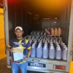 Worker with truck loaded with jugs of liquid, Joywash Marketing, Johor Bahru