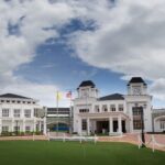 White colonial-style building exterior with clock tower and flags, Kota Seriemas Golf & Country Club, Seremban