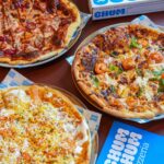 Three pizzas on plates with pizzeria box and menu card, Meriah By Serai Group @ TRX Mall KL, Kuala Lumpur