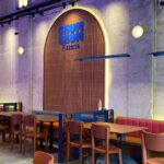 Restaurant seating area with booths and wall sign, Meriah By Serai Group @ TRX Mall KL, Kuala Lumpur