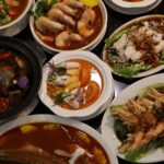 Assortment of seafood dishes in sauces on plates, Nyonya Kitchen & Caterers Sdn Bhd, Klang