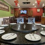 Round dining table set with plates for a banquet room, Nyonya Kitchen & Caterers Sdn Bhd, Klang