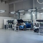 Mechanic working on cars in a garage bay, Optimal Premium Motors, Subang Jaya