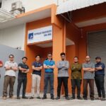 Staff posed outside office building with signboard, Petrolec Resources Sdn Bhd, Ampang