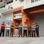 Staff posed outside company building with signboard, Petrolec Resources Sdn Bhd, Ampang