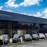 Car dealership showroom with vehicles parked outside, Proton Atiara Johan Body and Paint Center, Puchong