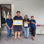 Staff posed at a home entrance holding a signboard, PT CLEAN Services, Cheras (Kuala Lumpur)
