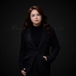 Studio portrait of a woman in black blazer, Royal Fansco Salon, Masai