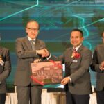 Men on stage handing over a framed award, Sabah International Convention Centre, Kota Kinabalu