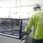 Worker operating packaging machine wearing uniform shirt, Sireh Emas Marketing Sdn.Bhd, Shah Alam