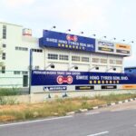 Building exterior with tyre shop signboard and brand logos, Swee Hing Tyres, Johor Bahru